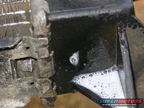radiator13.jpg With the radiator removed, ports plugged, and Windex on the tank, the leak is apparent, even at 7psi.

GO TO THE NEXT PIC...
