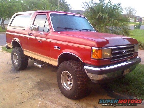 Red 1990 Ford Bronco with tan trim, 3/4 front view