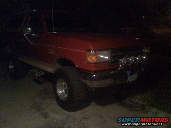Red pickup truck with off-road lights, 3/4 front view