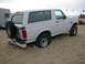 1988 Ford Bronco - This white Ford Bronco appears to be from the early 1990s, not 1988, and is stuck in the sand.