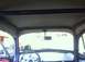1970 Volkswagen Beetle - The interior of a custom vehicle features a prominent purple roll cage and a beige headliner, viewed from the driver's seat.