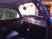 1970 Volkswagen Beetle - The interior of a custom Volkswagen Beetle features a yellow steering wheel lock and an orange shift knob, with a roll cage visible.