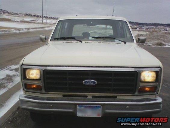 White Ford Bronco parked on a snowy road