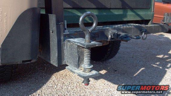 133.jpg This pin & spring locks the arm closed.  The spring keeps it from lift up without some deliberate force.  Two summers worth of off-roading, and it hasn't come out by itself yet.