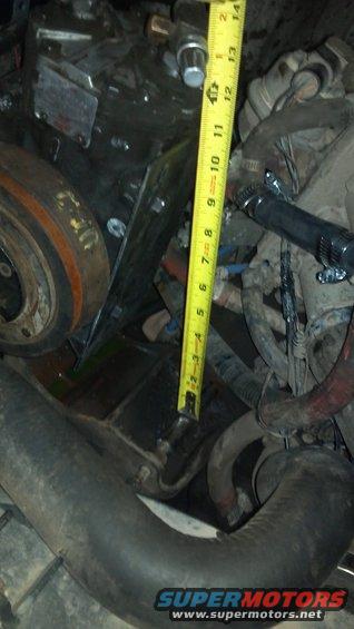 I'm thinking about some kind of turnbuckle with clevis mounts on the bracket and the round tube.    The angle of the tape measure approximates the angle of the adjuster.