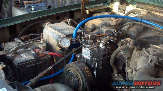 York 210 R air conditioning compressor from a '69 IH Travelall. I removed the smog pump, leaving the bracket in place.  One air line runs to the front quick disconnect, the other goes back to a 2 1/2 gallon air tank.  You can see my pressure gauge, the pressure relief, tank supply, pressure switch, and  supply line from the compressor