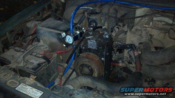 Here's the York mounted to the bracket, air lines all hooked up, and heater hoses re-routed.  All that's left is the electrical hookup, the belt, and some kind of adjuster to tighten the belt.