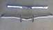 1973 Chevrolet Camaro - Two chrome bumpers displayed on a gray surface. The registry claims they are from a 1973 Chevrolet Camaro, but this is unconfirmed.