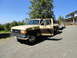 1966 International Scout 800 - This pickup truck appears to be from the late 1980s, likely a Ford F-Series, and is hitched to a trailer.