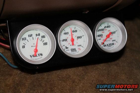 Three Equus gauges: volts, oil pressure, and water temperature