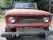 1966 International Scout 800 - Front view of a red 1966 International Scout 800, showing the distinctive grille and International badging. Another vehicle is visible in t…