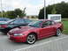 2003 Mercury Marauder - A red Ford Mustang coupe is parked in a lot next to other vehicles.