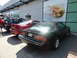 2003 Mercury Marauder - Three cars parked in front of a building with a large mural of a sandwich.