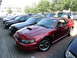 2003 Mercury Marauder - A red Ford Mustang is parked in a lot with other vehicles. The car has a distinctive hood scoop.