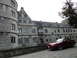 2003 Mercury Marauder - Red coupe parked in front of a historic stone building.