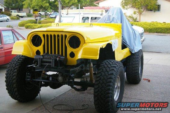 Yellow 1983 Jeep CJ7 front view with winch and tarp
