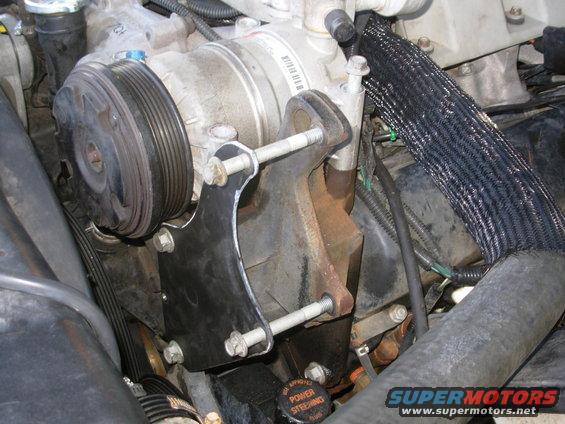 I started with an Aluminum template, then made this steel bracket.  The lower 2 short bolts came from the holes where the long bolts are now; they originally held the factory hose hook on the lifting eye.  Note the sharp V-notch in the lifting eye bracket pointing to the compressor, where the body of the alternator will fit.

http://www.dieselplace.com/forum/showthread.php?t=427664

Before installing ANY alternator, clean all its mounting surfaces thoroughly, and apply ELECTRICAL grease (not dielectric, or thermal, or chassis) to the mating surfaces.  If the alternator case isn't fully grounded to the block (and then continuously to each battery's negative post), it can't fully charge the batteries.

[url=http://www.supermotors.net/registry/media/825375][img]http://www.supermotors.net/getfile/825375/thumbnail/alternatormountboss.jpg[/img][/url]