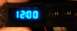 2005 Ford Crown Victoria - A close-up of a digital clock display showing 12:00, with buttons labeled H and M.