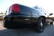 2004 Ford Crown Victoria - Rear view of a black 2004 Ford Crown Victoria showing its taillight and body lines.