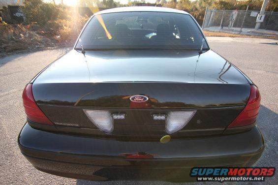 Black 2004 Ford Crown Victoria rear with Ford badge and police lights