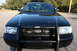 2004 Ford Crown Victoria - Front view of a black 2004 Ford Crown Victoria P71 police car with a push bar.