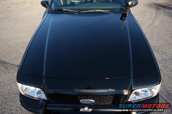 Front view of a black 2004 Ford Crown Victoria Police Interceptor with a push bar