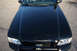 2004 Ford Crown Victoria - The front grille and headlights of a black Ford Crown Victoria Police Interceptor are visible.