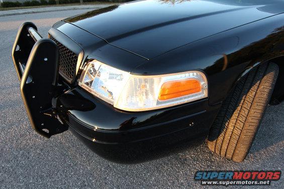 Black 2004 Ford Crown Victoria front corner with push bar and tire