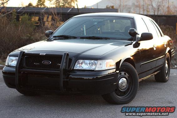 Black 2004 Ford Crown Victoria Police Interceptor with push bumper parked on asphalt