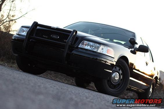Black Ford Crown Victoria with a push bar, front quarter view