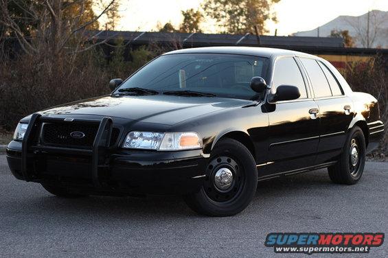 Black 2004 Ford Crown Victoria with a push bar, seen from a 3/4 front angle