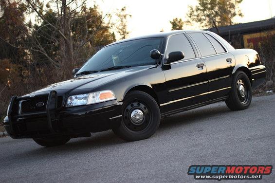 Black 2004 Ford Crown Victoria with push bar, 3/4 front view