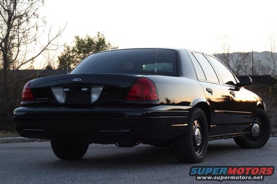 Black Ford Crown Victoria from the rear, parked on a street