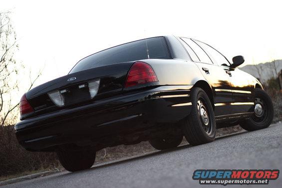 Black 2004 Ford Crown Victoria rear view, parked on asphalt