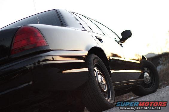 Black sedan, rear quarter view. 2004 Ford Crown Victoria