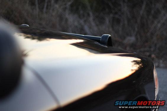 Black car hood with snorkel attachment, reflecting sunset