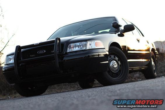 Black 2004 Ford Crown Victoria with push bar, front view, parked on asphalt