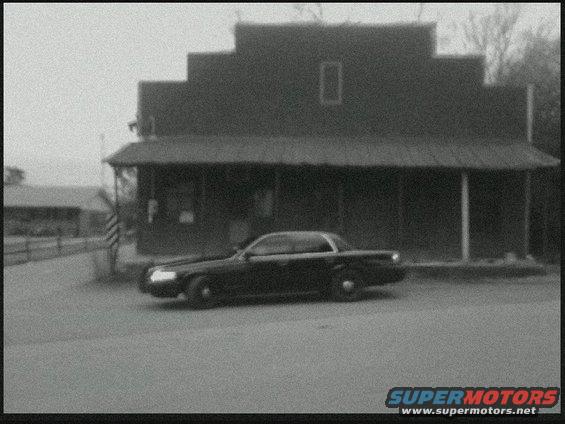 Black 2004 Ford Crown Victoria parked in front of a building