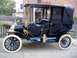 1909 Ford Model T - This antique automobile features a high-mounted steering wheel and a covered passenger compartment.