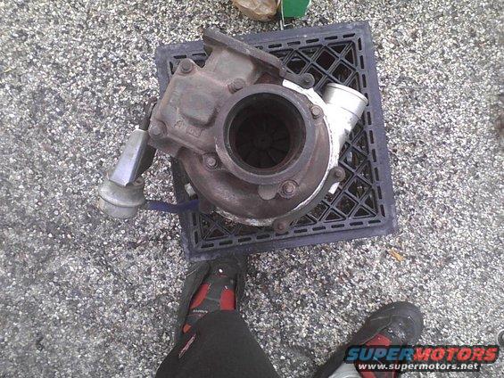 Turbocharger on a black grate, with feet in the foreground
