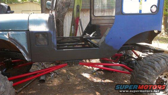 Off-road vehicle chassis with custom red suspension and large tires