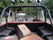 1961 International Scout 80 - View from the rear of an off-road vehicle's interior, a roll cage, roof lights, and a cluttered bed.