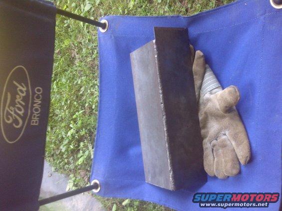Dark blue tarp with Ford Bronco logo and a metal piece with a glove