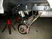1996 Ford Bronco - Close-up view of the rear suspension system of a vehicle, supported by jack stands.