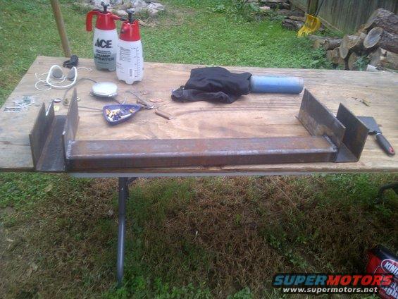 Metal fabrication parts on a table with sprayers and tools