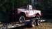 1961 International Scout 80 - A red International Scout is parked on a trailer, ready for transport.