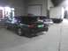 2003 Ford Crown Victoria - A dark sedan is parked in a lot at night, with other vehicles visible in the background.