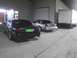 2003 Ford Crown Victoria - Two Ford Crown Victorias are parked next to each other outside a commercial building with a box truck nearby.
