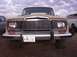 1988 Ford Bronco - Front view of a Jeep Wagoneer, showing its grille and headlights. A second vehicle is visible on the right.