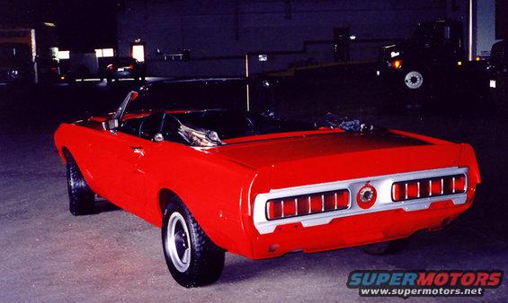 Red 1969 convertible muscle car rear view. Distinctive taillights and chrome trim